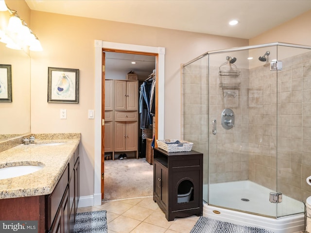 7674 Pine Knob Rd, Pasadena, MD 21122 - bathroom featuring a stall shower, tile patterned floors, double vanity, a walk in closet, and recessed lighting