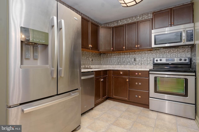 84 Transverse Unit 84, Middle River, MD 21220 - kitchen featuring appliances with stainless steel finishes, backsplash, dark brown cabinets, and a sink