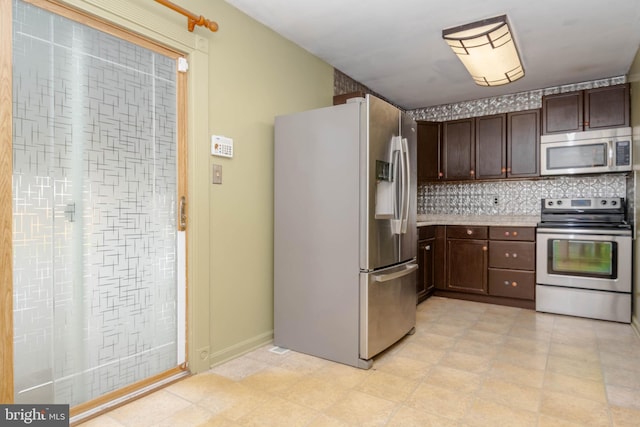 84 Transverse Unit 84, Middle River, MD 21220 - kitchen featuring stainless steel appliances, dark brown cabinetry, tasteful backsplash, light countertops, and light floors