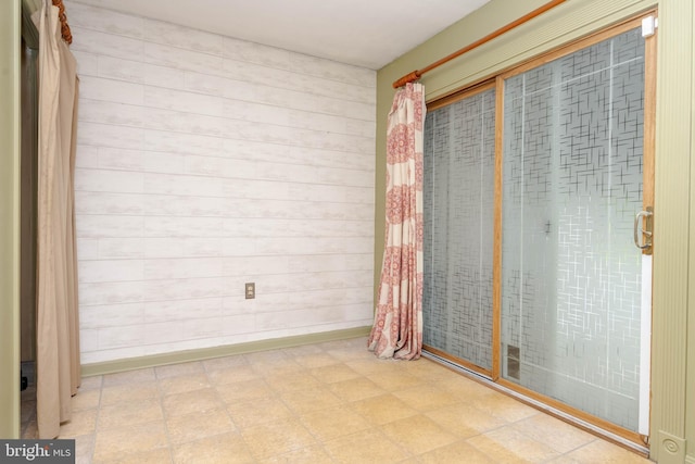 84 Transverse Unit 84, Middle River, MD 21220 - unfurnished room featuring tile patterned floors and wood walls