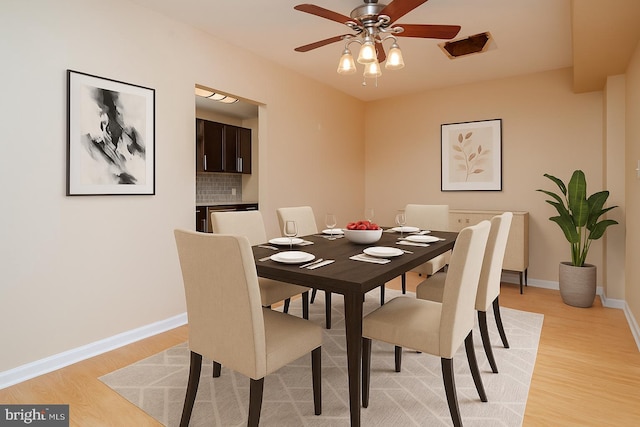 84 Transverse Unit 84, Middle River, MD 21220 - dining room with light wood-style floors, a ceiling fan, and baseboards