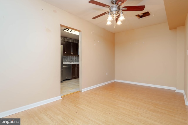 84 Transverse Unit 84, Middle River, MD 21220 - empty room with light wood finished floors, ceiling fan, and baseboards