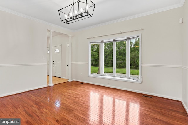 3547 Green Spring Rd, Havre De Grace, MD 21078 - unfurnished room with ornate columns, wood-type flooring, crown molding, baseboards, and a chandelier