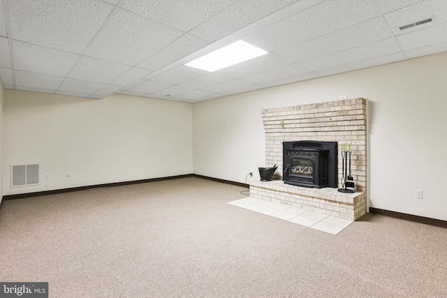 3547 Green Spring Rd, Havre De Grace, MD 21078 - unfurnished living room featuring a wood stove, carpet flooring, baseboards, and a drop ceiling