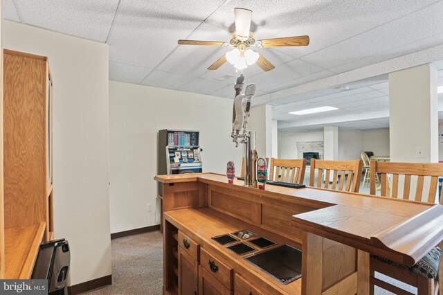 3547 Green Spring Rd, Havre De Grace, MD 21078 - carpeted dining room featuring a drop ceiling, baseboards, ceiling fan, and a fireplace