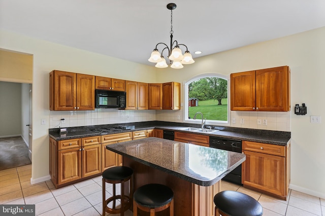 3547 Green Spring Rd, Havre De Grace, MD 21078 - kitchen with a sink, black appliances, a breakfast bar, light tile patterned floors, and decorative light fixtures
