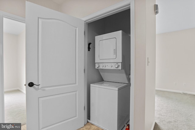 3547 Green Spring Rd, Havre De Grace, MD 21078 - laundry area with stacked washer / dryer, light colored carpet, and baseboards
