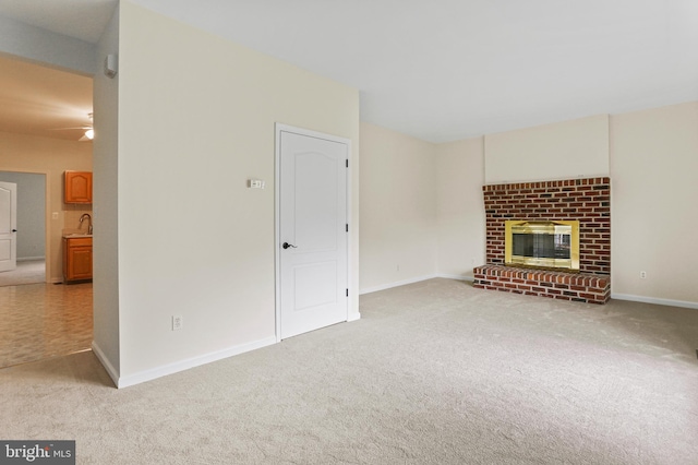 3547 Green Spring Rd, Havre De Grace, MD 21078 - unfurnished living room with light carpet, a brick fireplace, a sink, ceiling fan, and baseboards