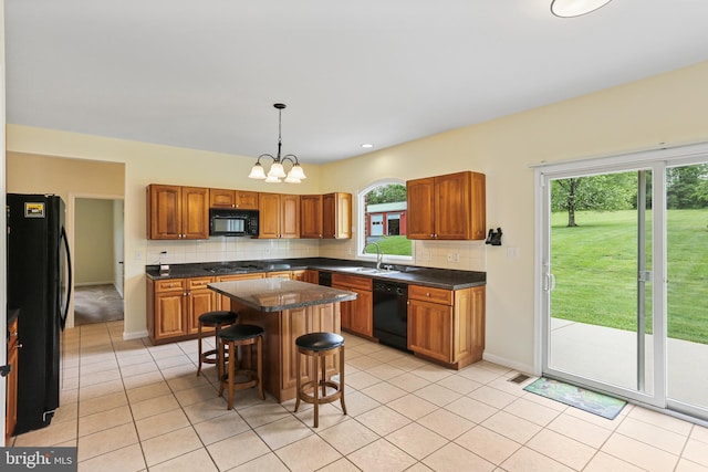 3547 Green Spring Rd, Havre De Grace, MD 21078 - kitchen featuring black appliances, tasteful backsplash, dark countertops, a kitchen breakfast bar, and a sink