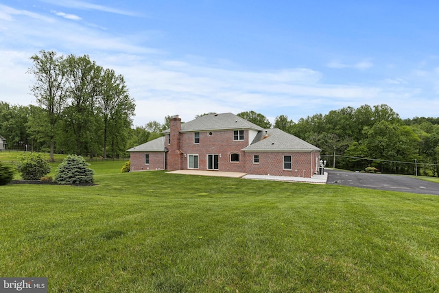3547 Green Spring Rd, Havre De Grace, MD 21078 - rear view of property with a patio, a yard, a chimney, and brick siding