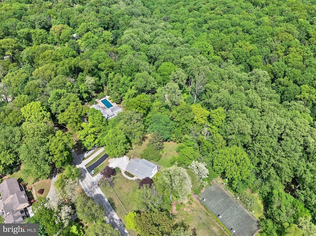 aerial view of property's location featuring a forest