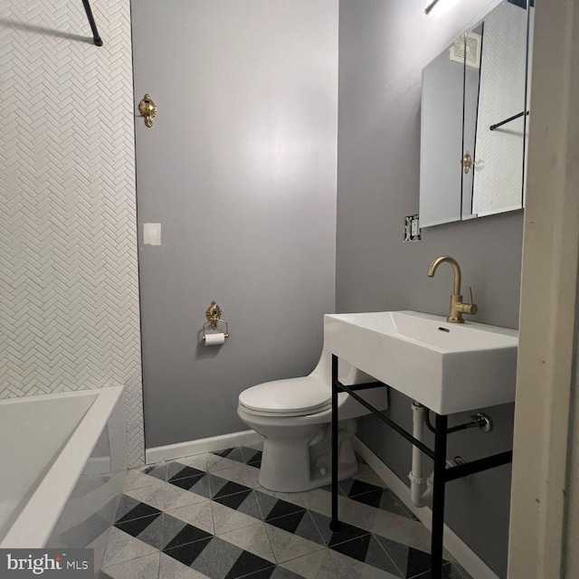 2947 W Girard Ave, Philadelphia, PA 19130 - bathroom with baseboards, toilet, and tile patterned flooring