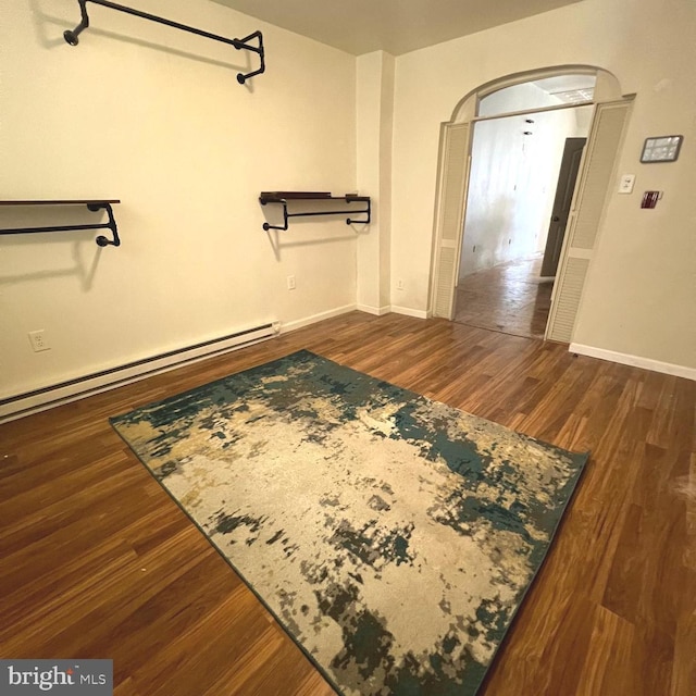 2947 W Girard Ave, Philadelphia, PA 19130 - walk in closet featuring a baseboard heating unit, wood finished floors, and arched walkways