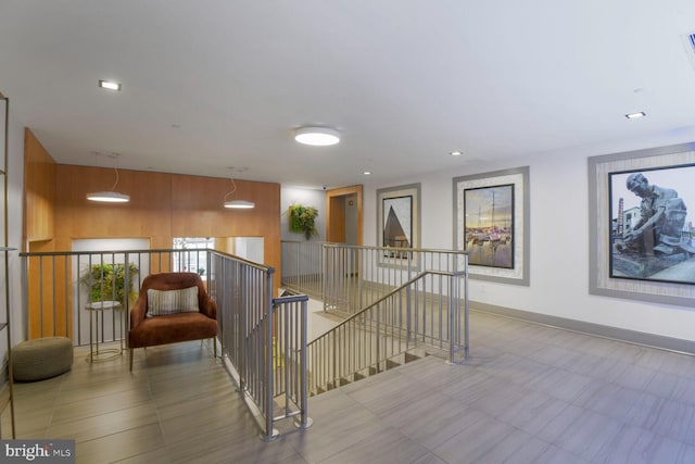 staircase featuring baseboards and recessed lighting