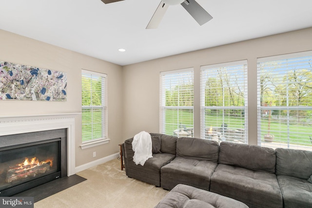 living area featuring a ceiling fan, baseboards, plenty of natural light, and recessed lighting