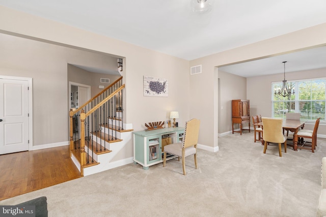 dining room with a chandelier, baseboards, stairway, and carpet flooring