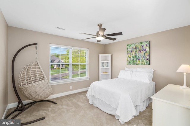 bedroom featuring baseboards, ceiling fan, and light colored carpet