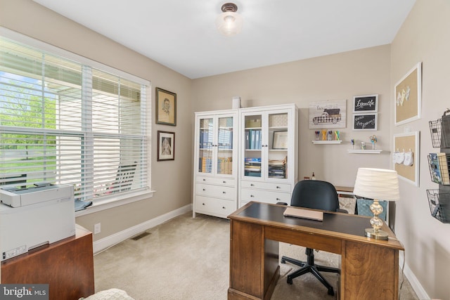 office space with baseboards and light colored carpet