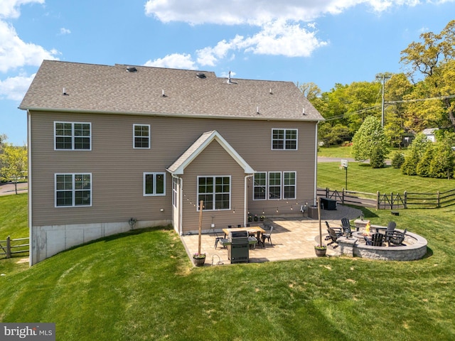 back of house with a fire pit and a patio