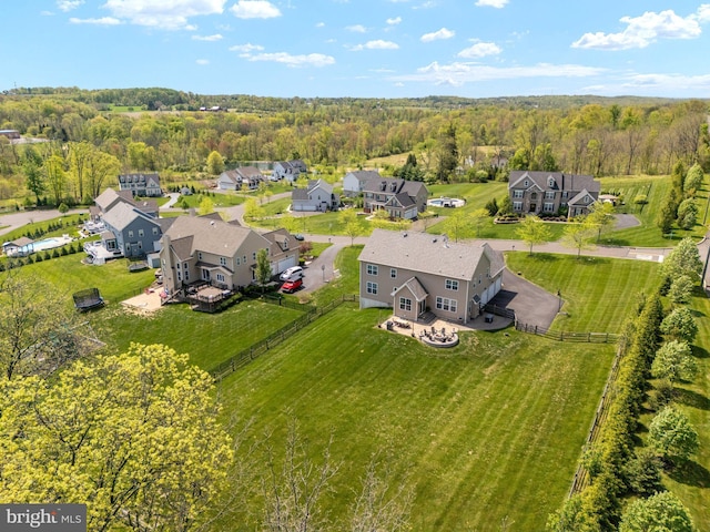 aerial perspective of suburban area with a forest
