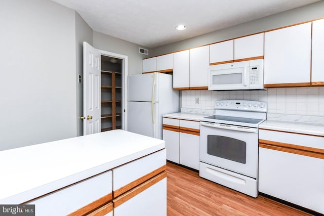2156 Commissary Cir, Odenton, MD 21113 - kitchen with white appliances, light countertops, backsplash, white cabinets, and recessed lighting