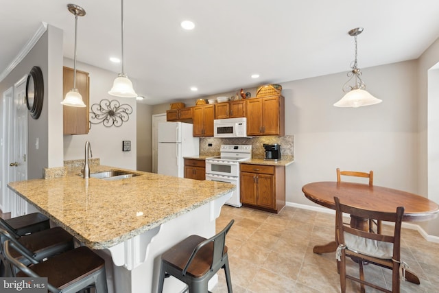 35934 Newberry Crossing Pl, Round Hill, VA 20141 - kitchen with white appliances, a sink, brown cabinets, a peninsula, and a breakfast bar area