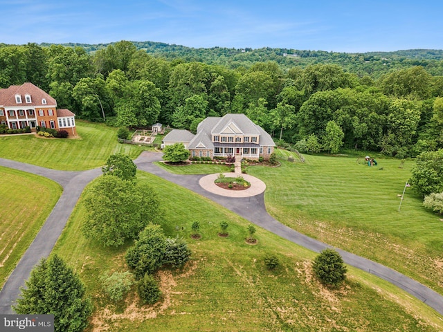 view of subject property featuring a heavily wooded area