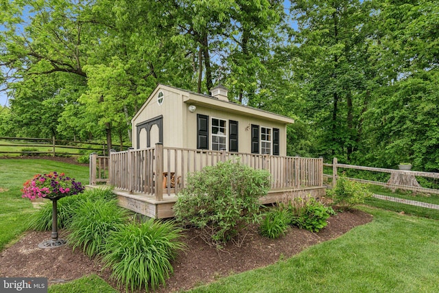 view of front of house with a wooden deck and a chimney