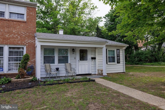 19 Rittenhouse Dr, Willingboro, NJ 08046 - view of front of home with covered porch, a chimney, and a front lawn
