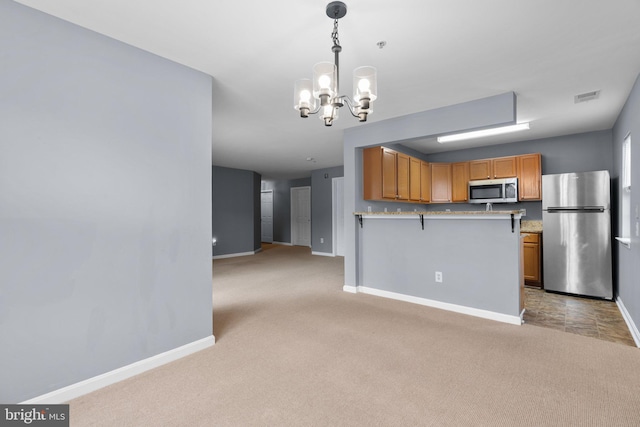 9150 Gracious End Ct Unit 104, Columbia, MD 21046 - kitchen with appliances with stainless steel finishes, a chandelier, baseboards, and light colored carpet