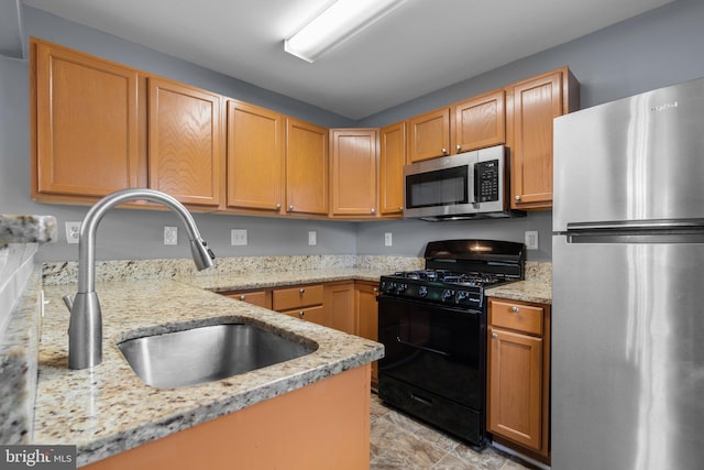 9150 Gracious End Ct Unit 104, Columbia, MD 21046 - kitchen featuring appliances with stainless steel finishes, a sink, and light stone countertops