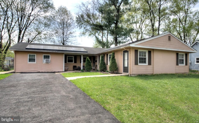 24 Edgewater Ln, Willingboro, NJ 08046 - ranch-style house with solar panels, a front lawn, driveway, and covered porch