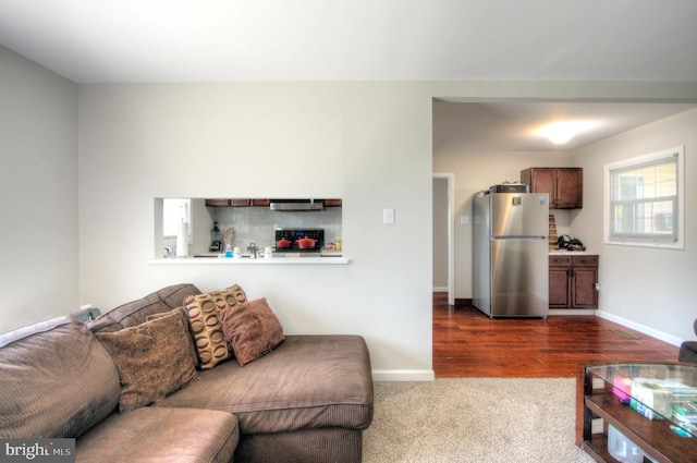 24 Edgewater Ln, Willingboro, NJ 08046 - living area with baseboards, dark colored carpet, and dark wood-style flooring