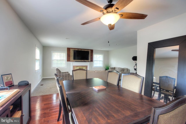 24 Edgewater Ln, Willingboro, NJ 08046 - dining space featuring dark wood-type flooring, a ceiling fan, a fireplace, and baseboards