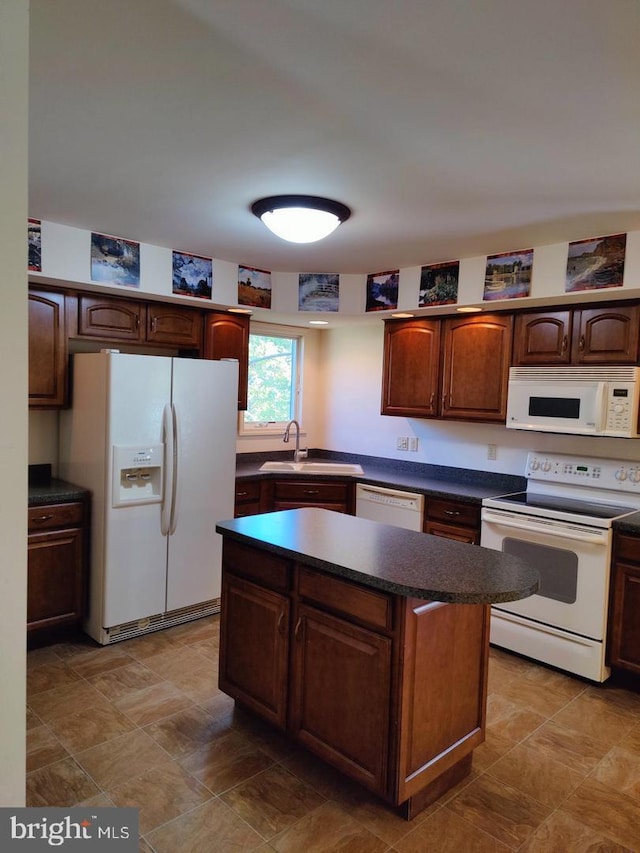 576 Kelker St, Oberlin, PA 17113 - kitchen featuring white appliances, dark countertops, a sink, and a center island