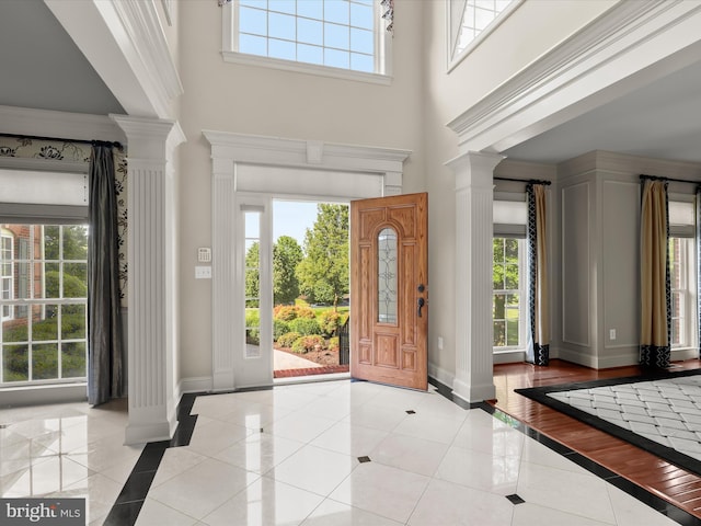 12810 Macbeth Farm Ln, Clarksville, MD 21029 - entryway featuring decorative columns, inlaid floor details, baseboards, a high ceiling, and light tile patterned flooring