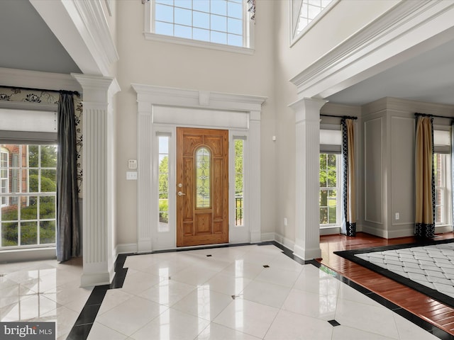 12810 Macbeth Farm Ln, Clarksville, MD 21029 - entrance foyer featuring ornate columns, inlaid floor details, baseboards, a high ceiling, and healthy amount of natural light
