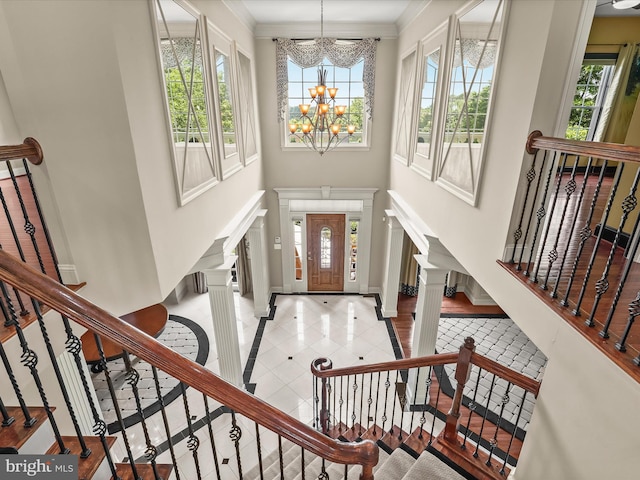 12810 Macbeth Farm Ln, Clarksville, MD 21029 - tiled entryway featuring inlaid floor details, a chandelier, stairs, ornamental molding, and baseboards