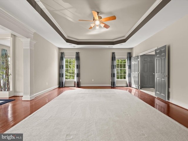 12810 Macbeth Farm Ln, Clarksville, MD 21029 - unfurnished bedroom featuring a raised ceiling, wood finished floors, multiple windows, crown molding, and ornate columns