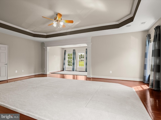 12810 Macbeth Farm Ln, Clarksville, MD 21029 - unfurnished bedroom featuring wood finished floors, a tray ceiling, decorative columns, baseboards, and crown molding