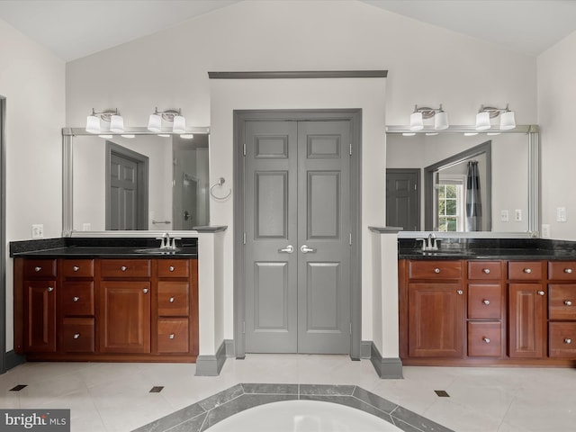12810 Macbeth Farm Ln, Clarksville, MD 21029 - full bathroom featuring vaulted ceiling, a closet, two vanities, and tile patterned floors