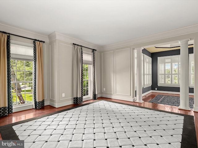 12810 Macbeth Farm Ln, Clarksville, MD 21029 - empty room featuring ornate columns, wood finished floors, a decorative wall, and crown molding