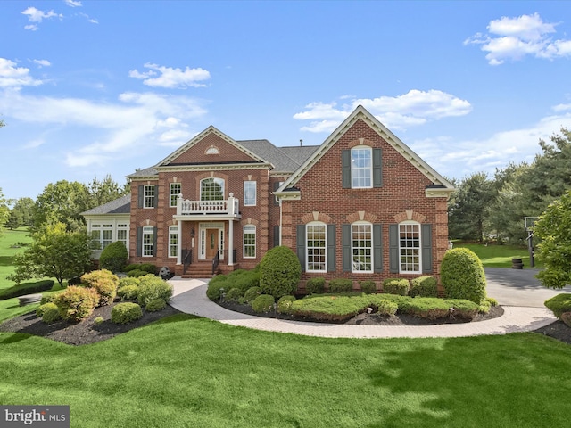12810 Macbeth Farm Ln, Clarksville, MD 21029 - colonial-style house with brick siding, a front yard, and a balcony