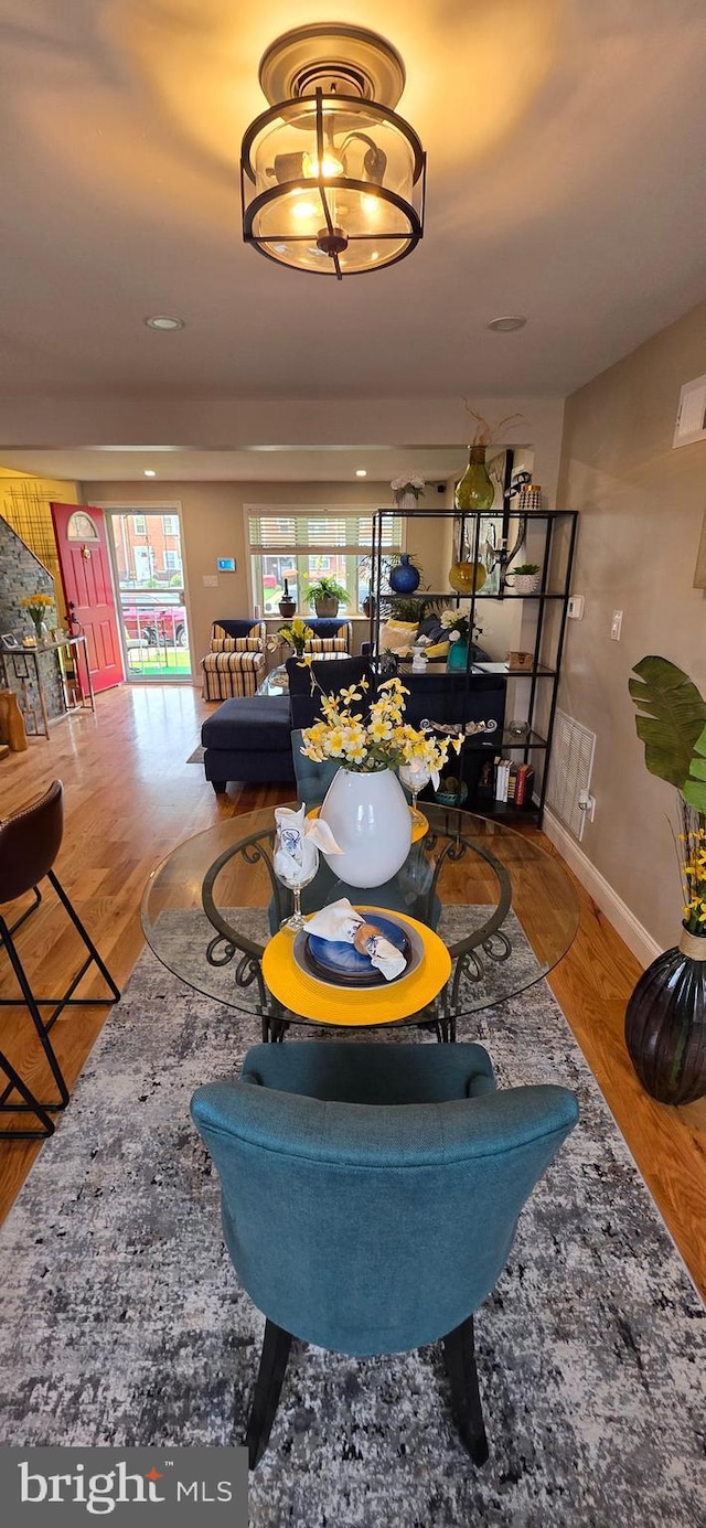 living room with plenty of natural light, baseboards, and wood finished floors
