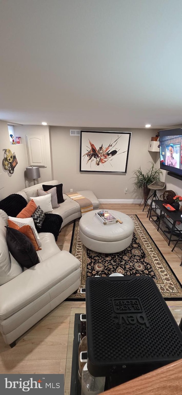 living area featuring light wood-type flooring and baseboards