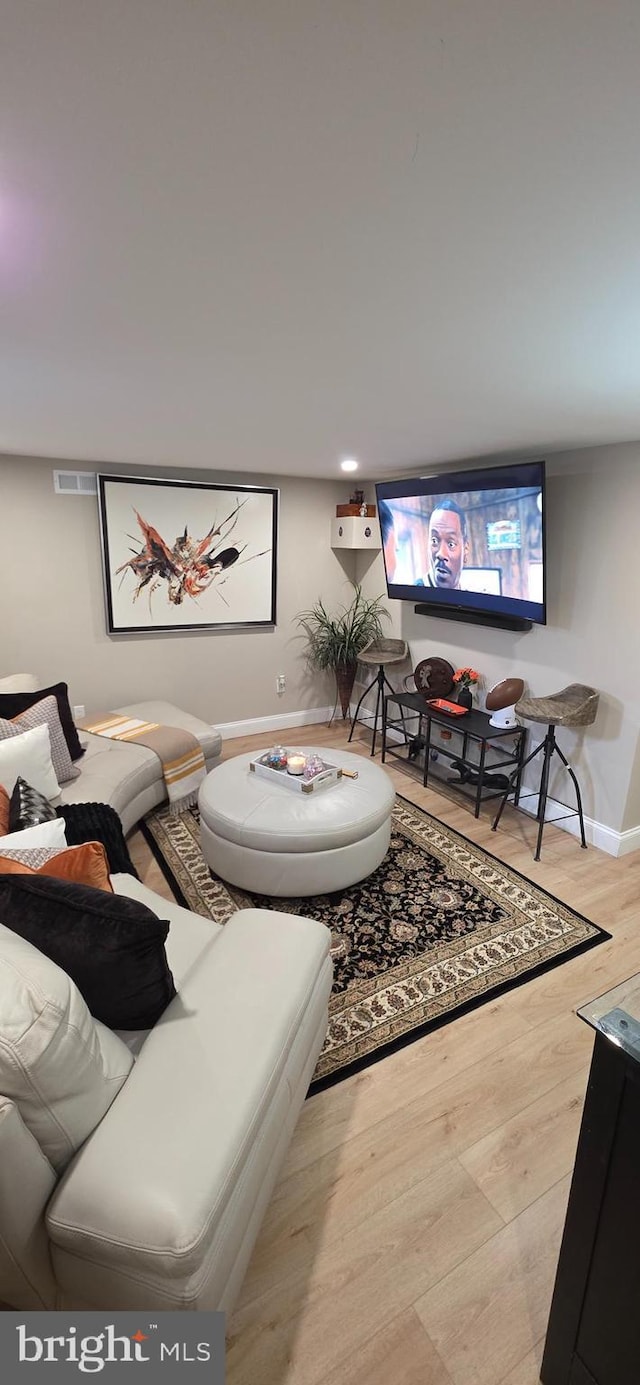 living area featuring wood finished floors and baseboards