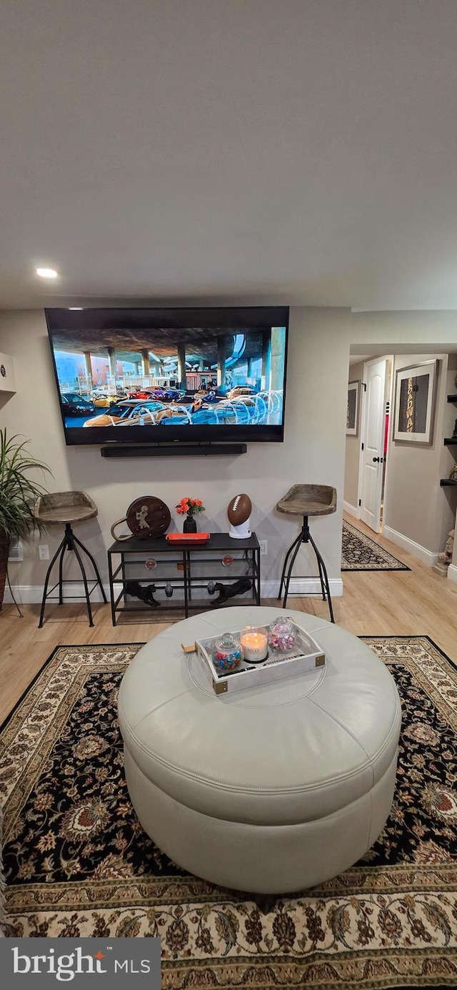 living area with light wood finished floors and baseboards