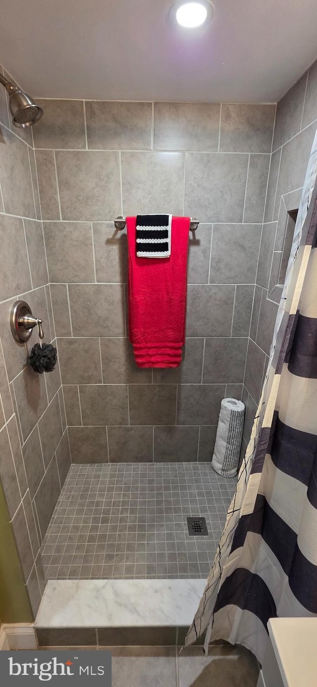 bathroom with tiled shower