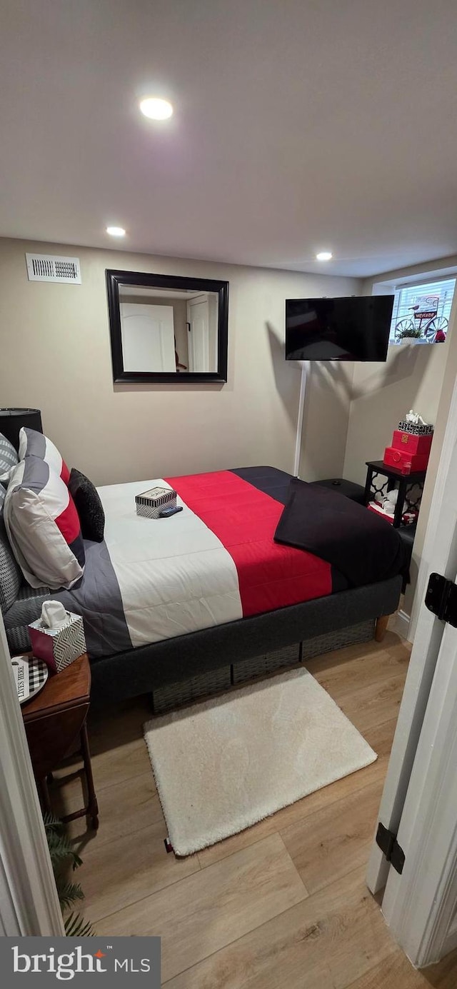 bedroom featuring wood finished floors and recessed lighting
