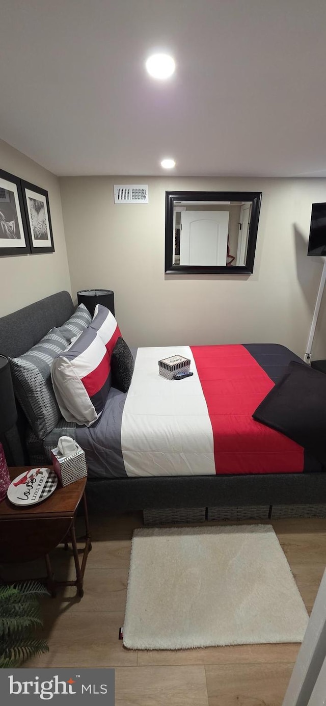 bedroom featuring wood finished floors and recessed lighting
